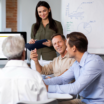 People using digital device while in a meeting