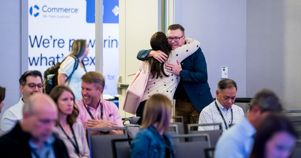 man hugging woman at conference
